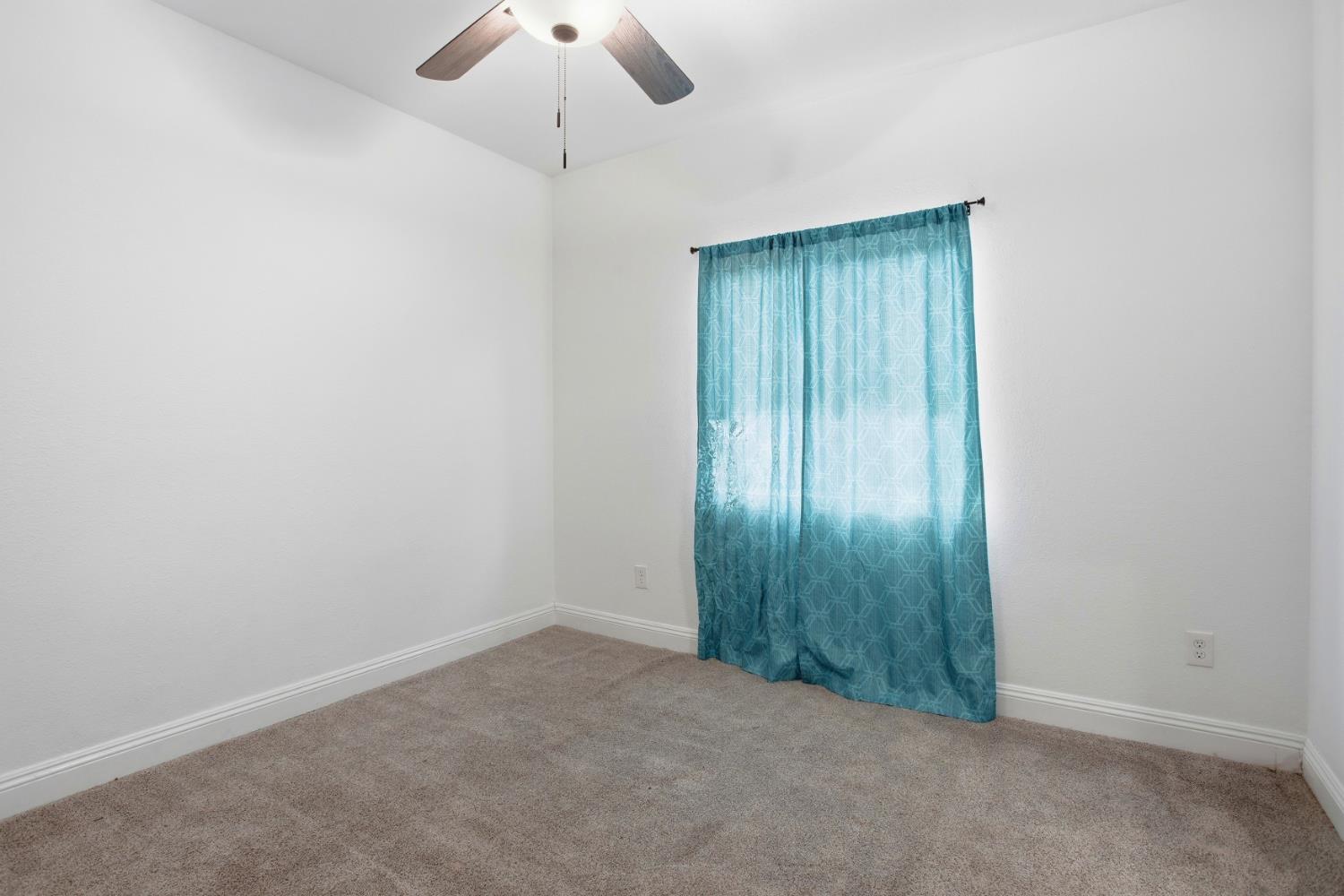 5680 Power Inn Road Sacramento, CA 95824 - Photo 24 of 48 an empty room with a chandelier fan