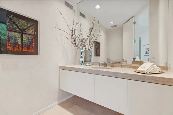 a bathroom with a granite countertop sink and a mirror