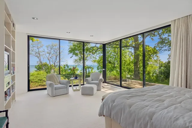 a bedroom with a large bed and a large window