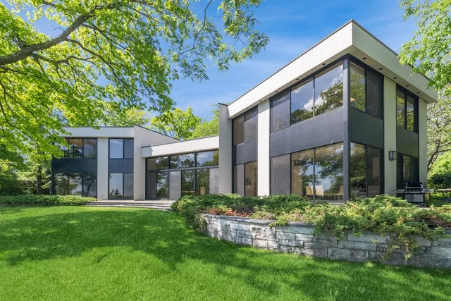 a front view of house with a garden