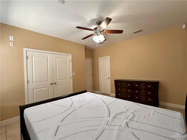 a bedroom with a bed and a dresser