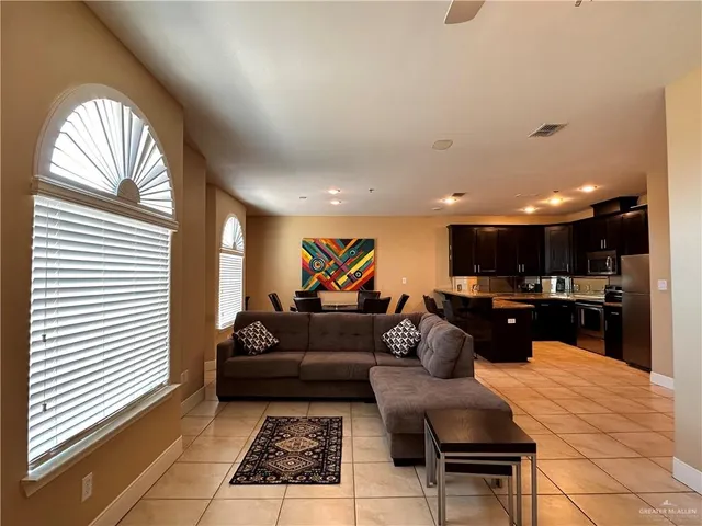 a living room with furniture and a chandelier