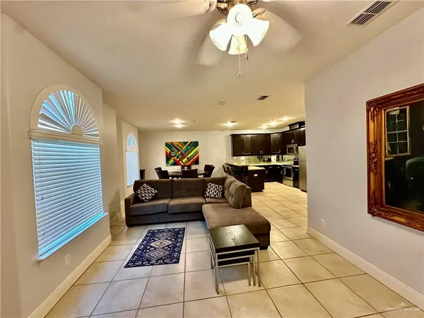 a living room with furniture a rug and a window