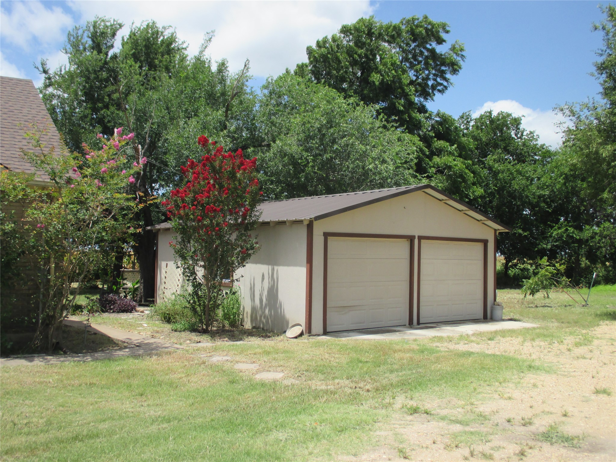 12610 Pecan School Road Bartlett, TX 76511 - Photo 5 of 21 A detached two-car garage provides ample parking and storage with a durable metal roof.