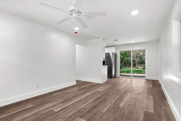 wooden floor in an empty room with a window
