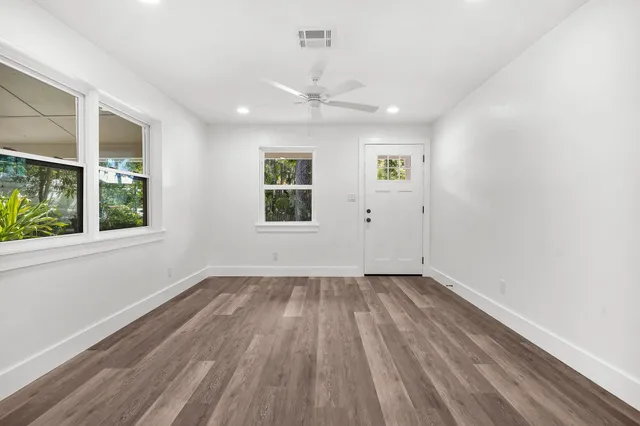 wooden floor in an empty room with a window