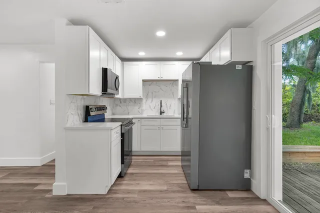 a kitchen with stainless steel appliances a refrigerator stove and microwave