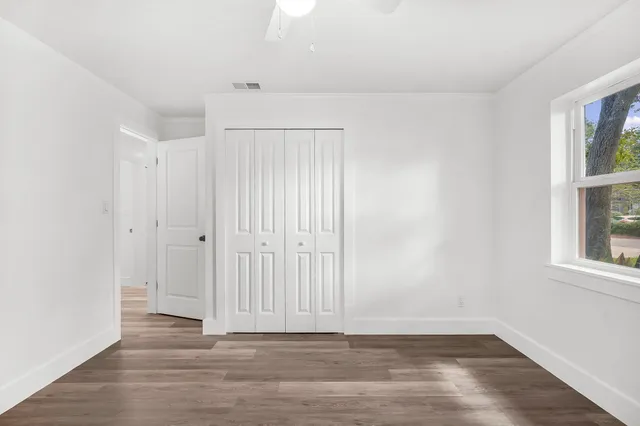 a view of a hallway with wooden floor