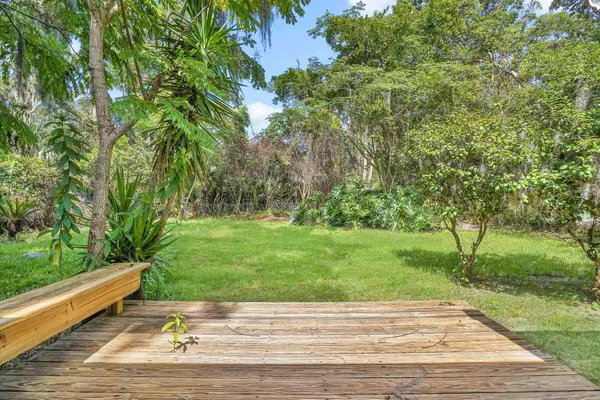 a garden with trees in front of it