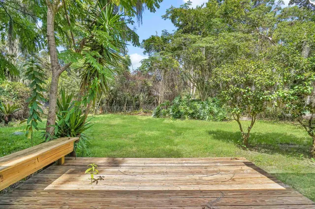 a garden with trees in front of it