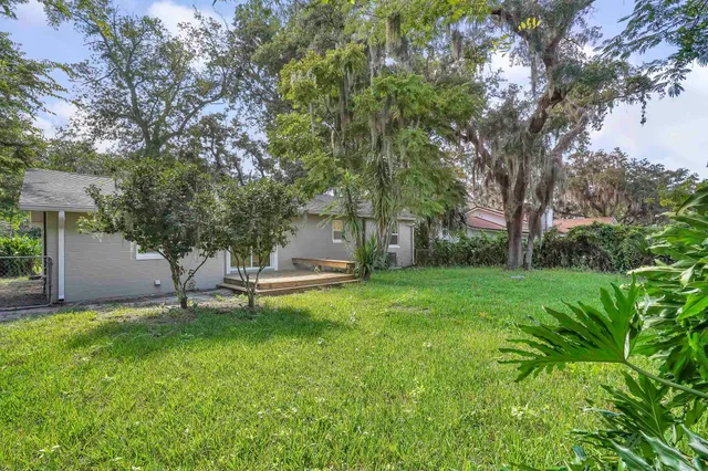 a view of a house with a backyard