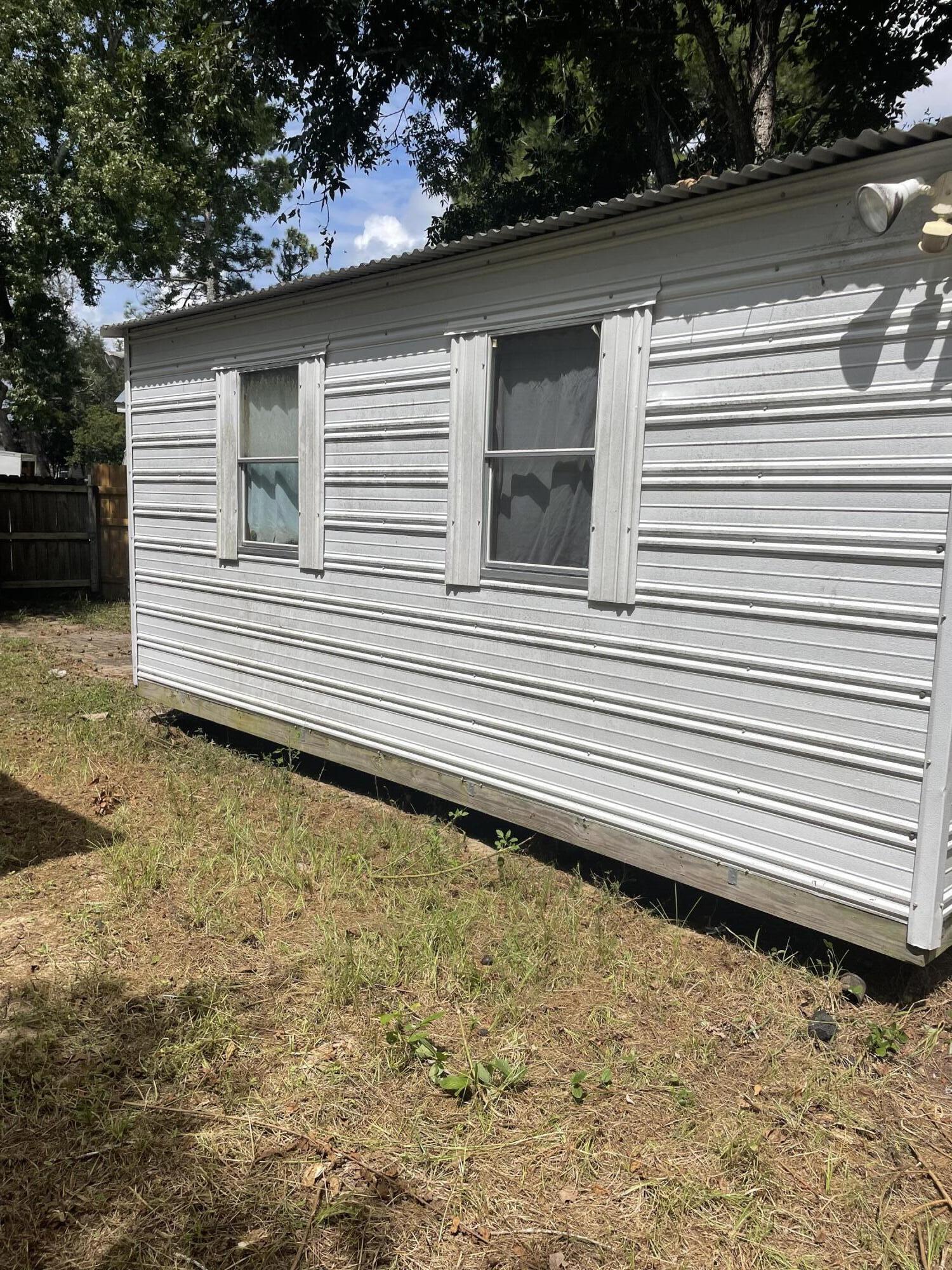 1412 Cape Lane Niceville, FL 32578 - Photo 21 of 23 a side of a house with a roof