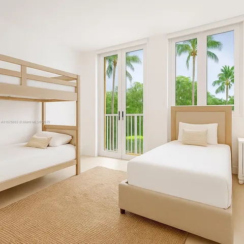 a bedroom with a large bed and a large window