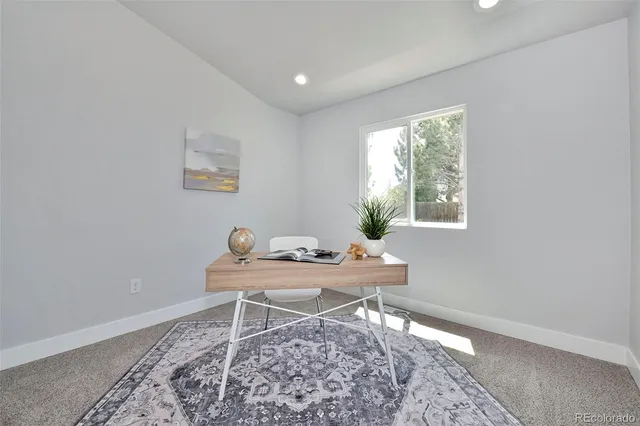 a workspace with furniture and window