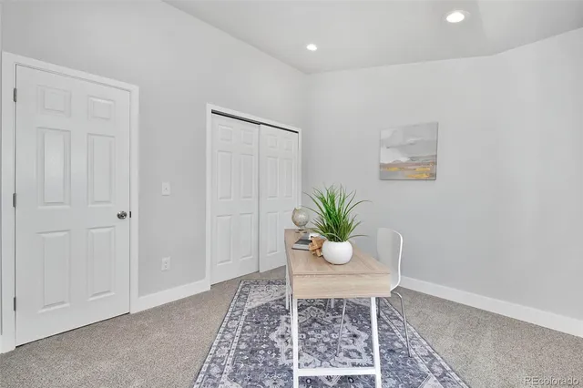 a view of a workspace room with wooden floor and a potted plant