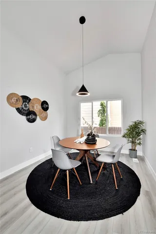 a view of a dining room with a table and chairs