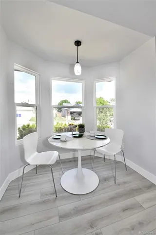 a dining room with furniture and window
