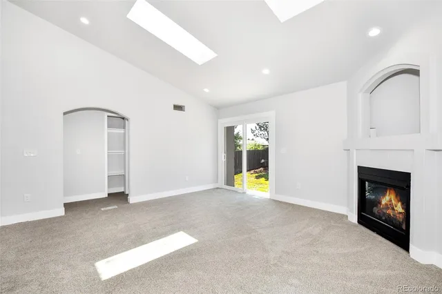 a view of an empty room with a fireplace