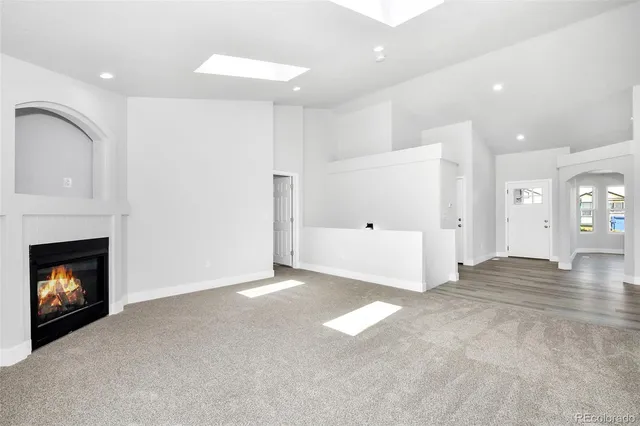 a view of an empty room with a fireplace