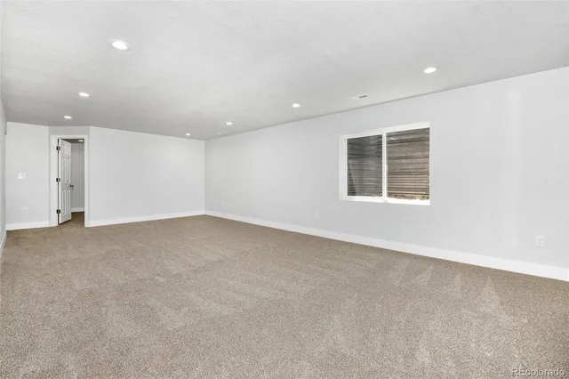 an empty room with a empty space and windows