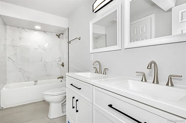 a bathroom with a sink a toilet and a bathtub