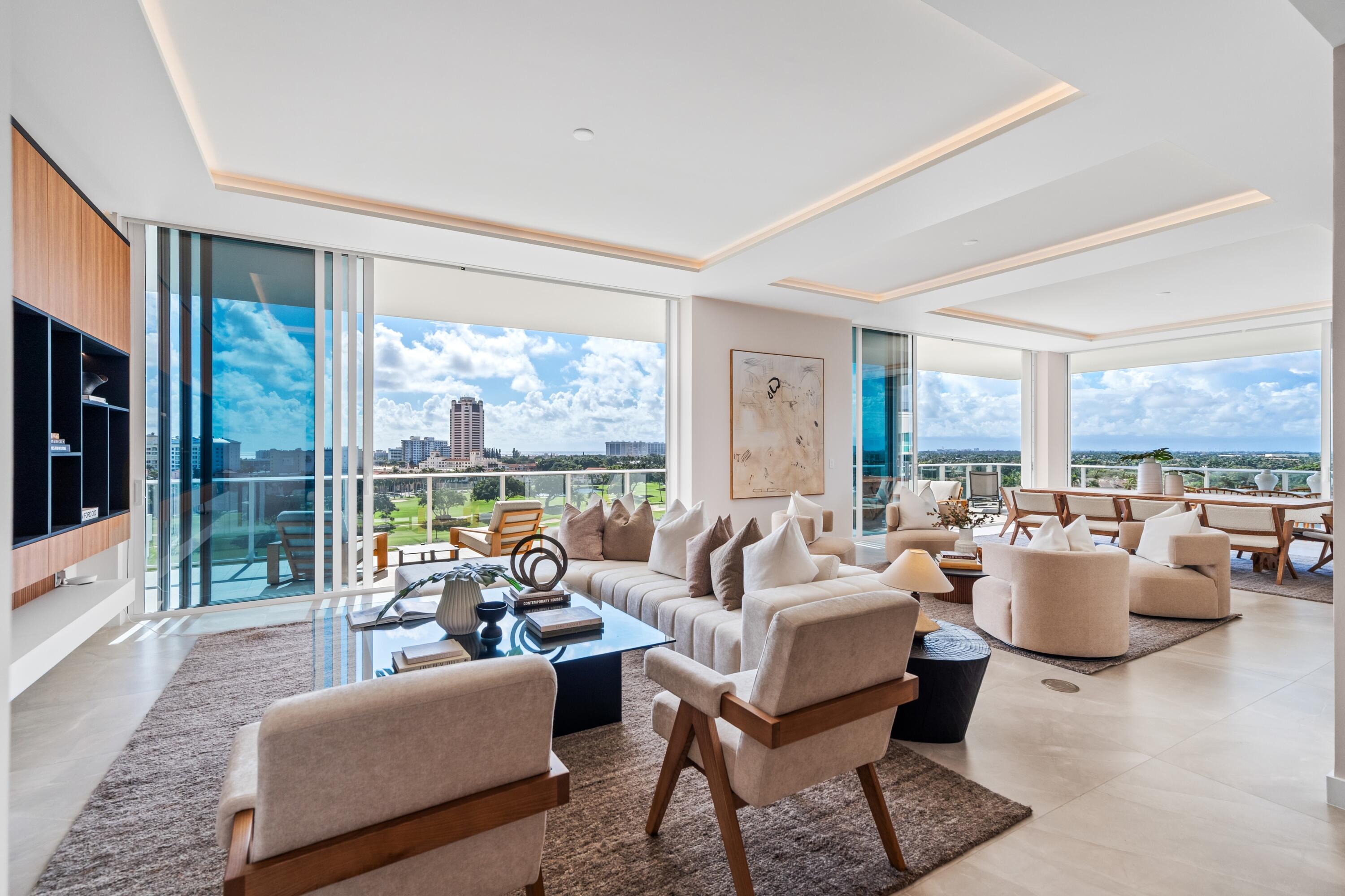 a living room with patio furniture and a large window