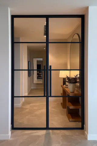 a view of living room filled with furniture and a lamp