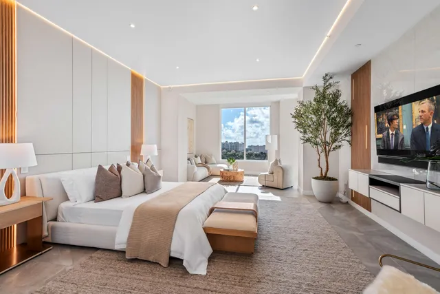 a bedroom with a bed and a mirror