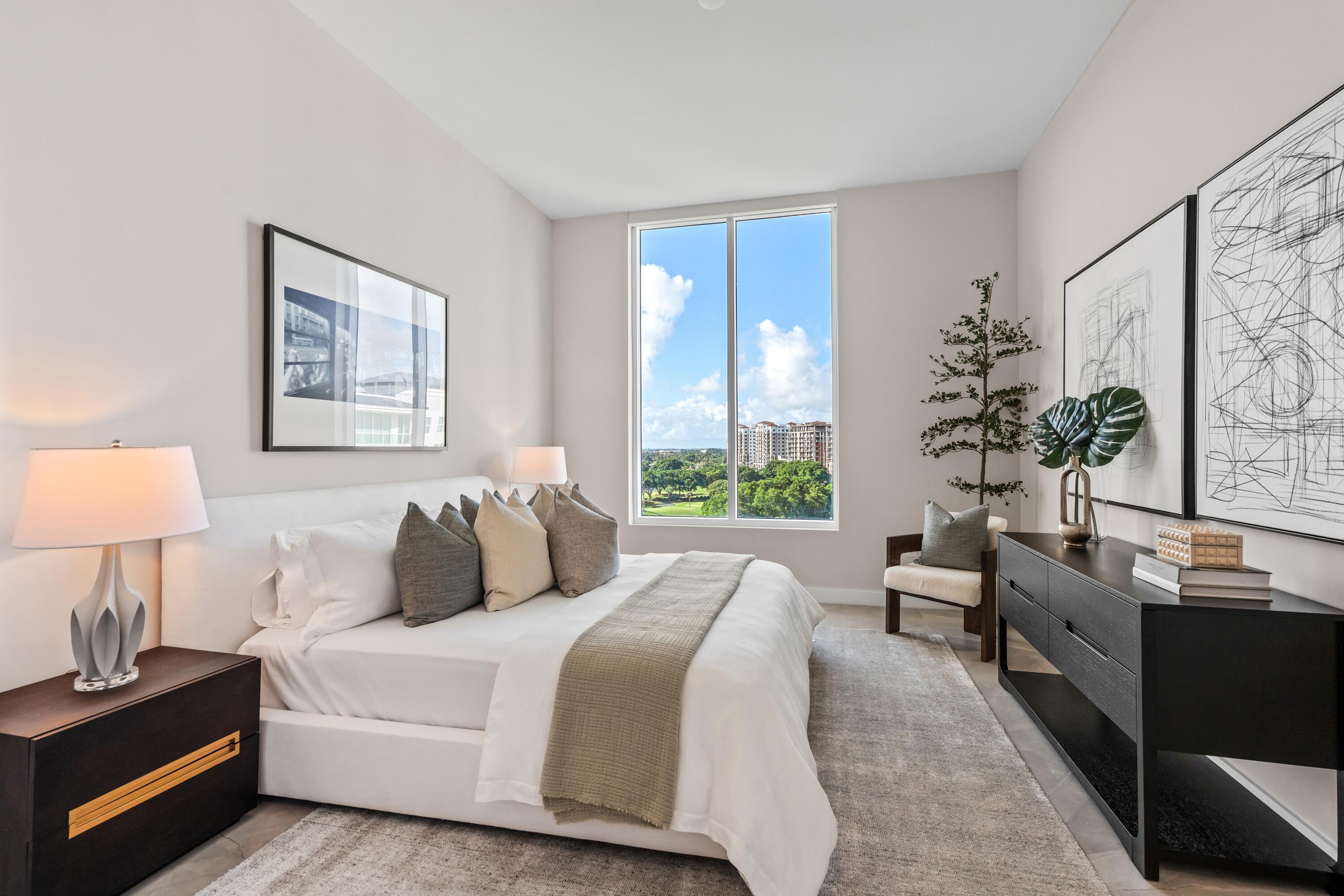 220 Southeast Mizner Boulevard, Unit PH24 Boca Raton, FL 33432 - Photo 22 of 51 a bedroom with bed and a potted plant