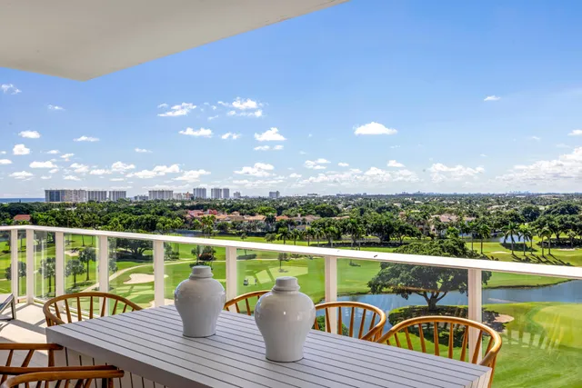 a view of a balcony with mountain view and wooden floor