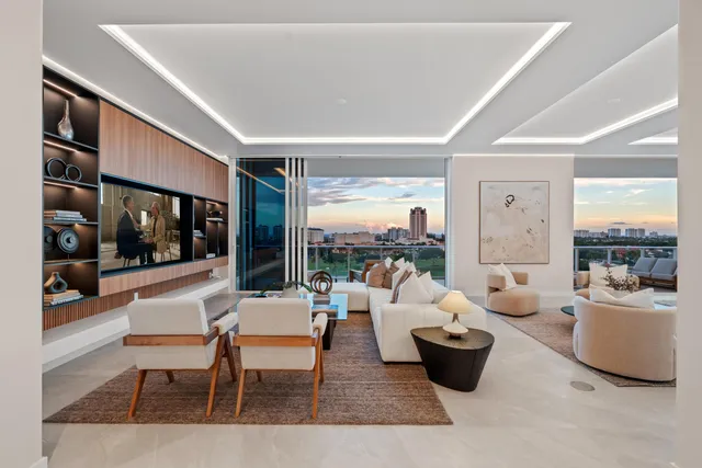 a dining room with furniture a chandelier and outdoor view