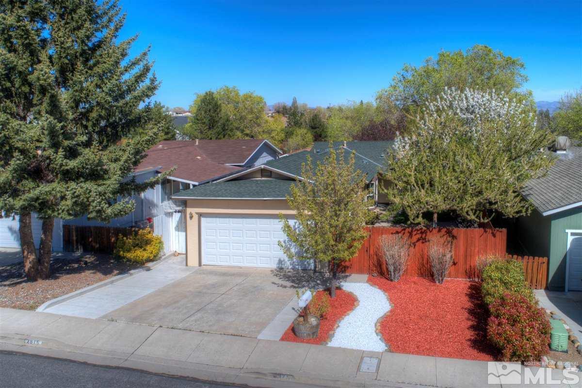 2975 Andrea Street Reno, NV 89503 - Photo 1 of 28 a view of a white house with a small yard and a large tree