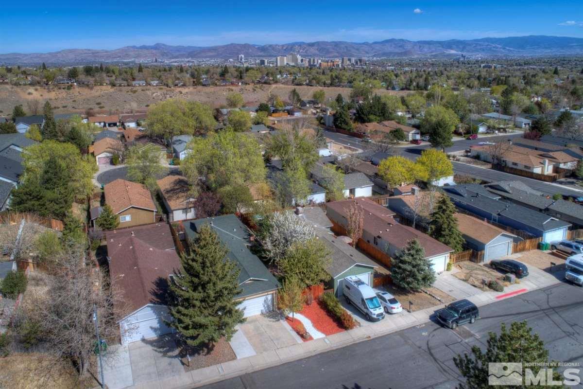 2975 Andrea Street Reno, NV 89503 - Photo 28 of 28 an aerial view of a city with lots of residential buildings and mountain view in back