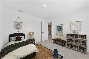 a bedroom with furniture and a book shelf