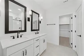 a bathroom with a double vanity sink mirror and