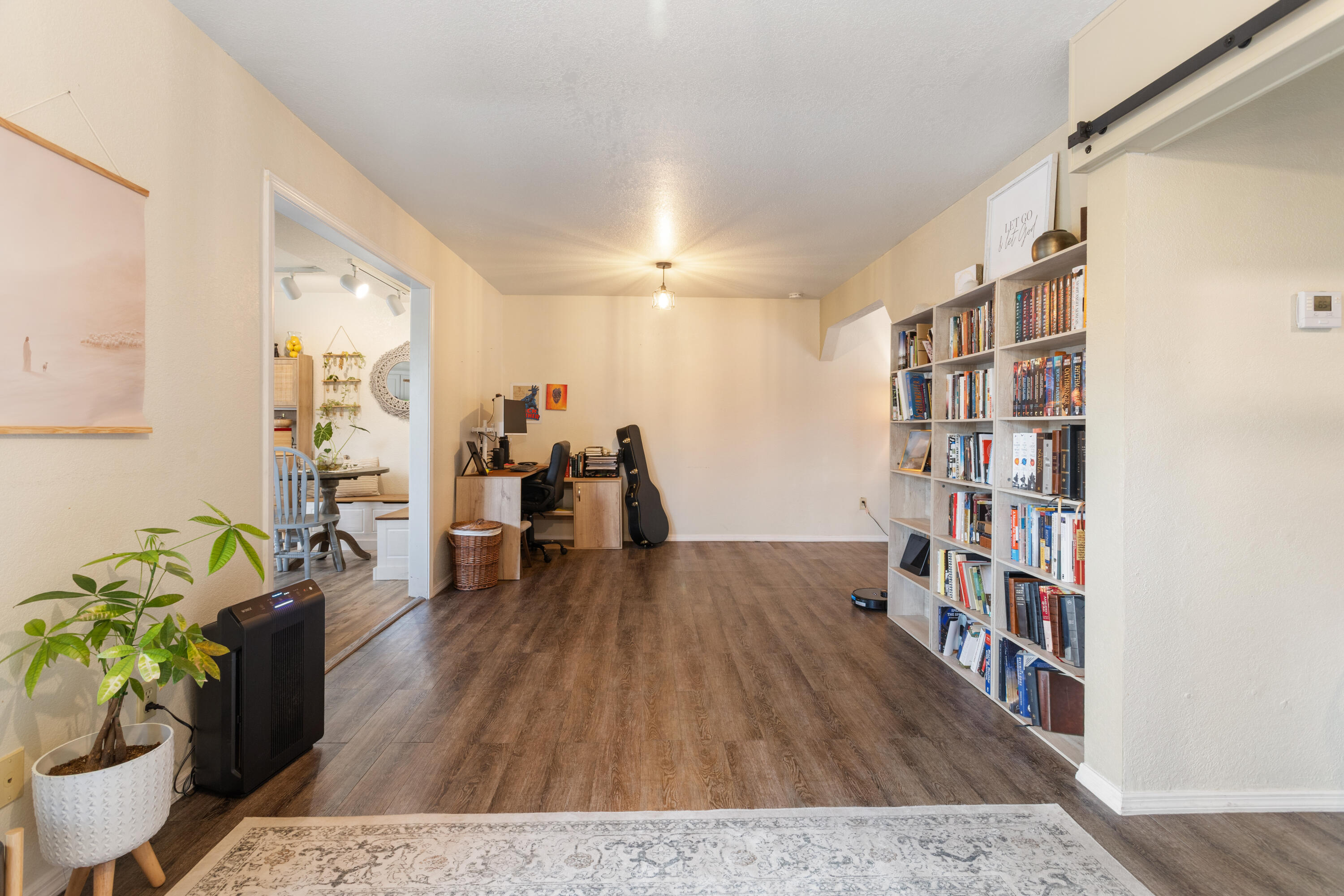 771 Flower Ash Lane Redding, CA 96003 - Photo 11 of 24 a living room with furniture and a book shelf