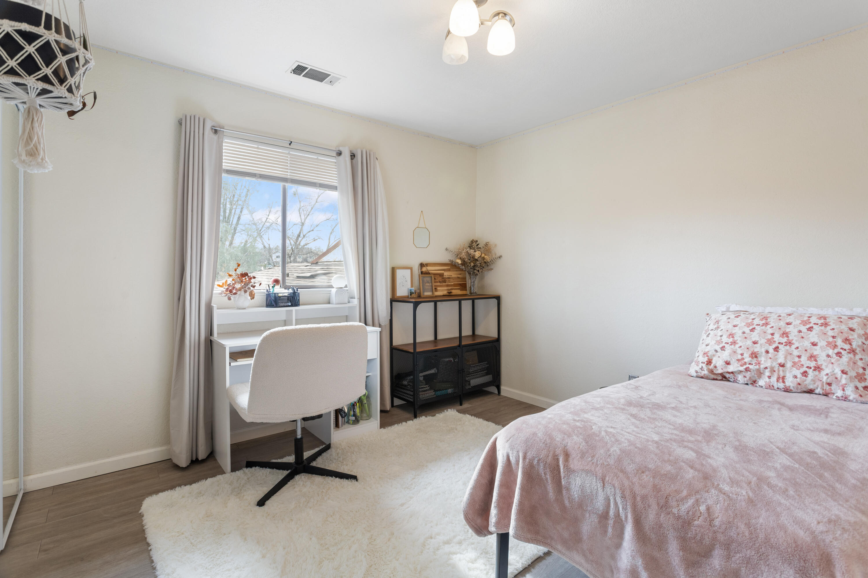 771 Flower Ash Lane Redding, CA 96003 - Photo 19 of 24 a bedroom with a bed a table and chair