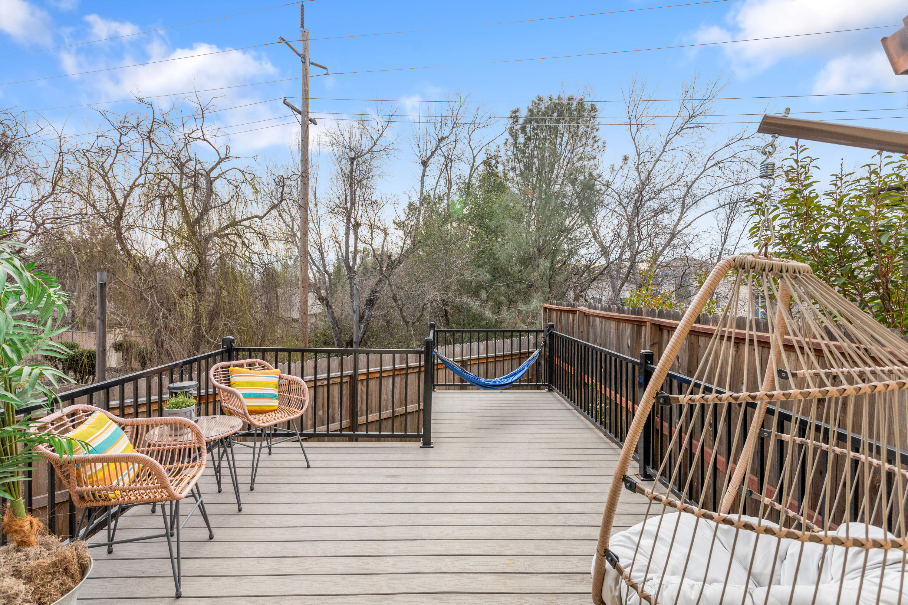 771 Flower Ash Lane Redding, CA 96003 - Photo 20 of 24 a view of a roof deck with table and chairs with wooden floor and fence