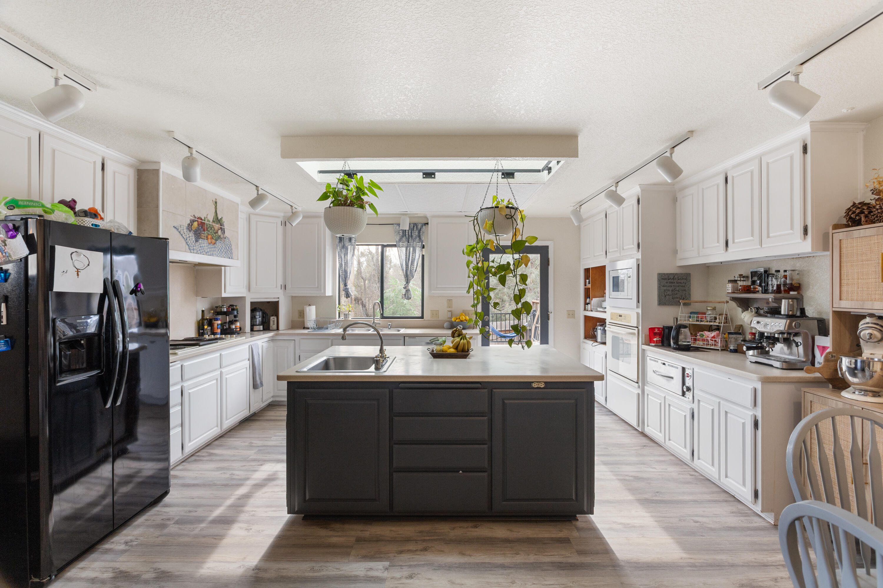 771 Flower Ash Lane Redding, CA 96003 - Photo 4 of 24 a kitchen with a sink stove and cabinets