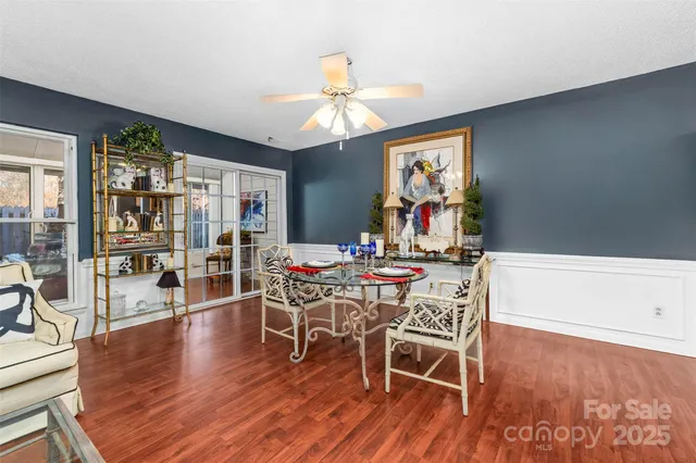 a view of a dining room with furniture wooden floor and chandelier