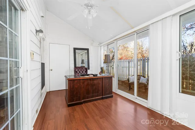 a view of a room with wooden floor and balcony