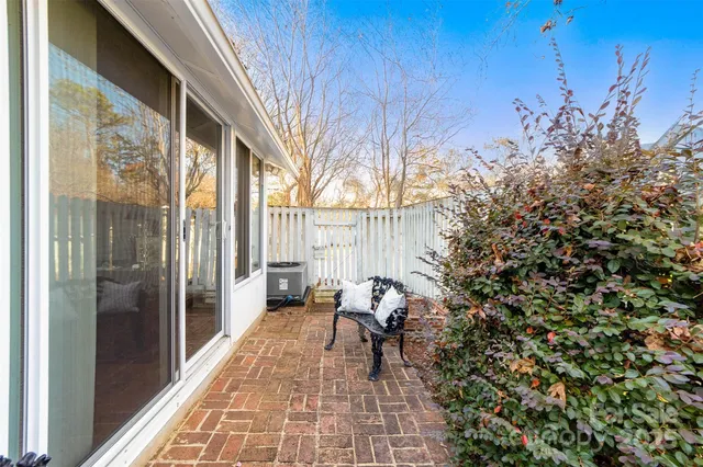 a balcony with wooden floor and outdoor seating