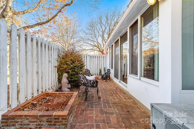 a balcony with furniture and a potted plant