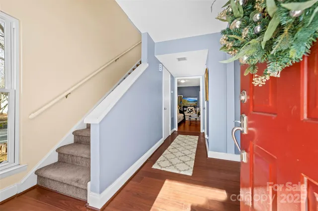 a view of entryway with wooden floor and stairs
