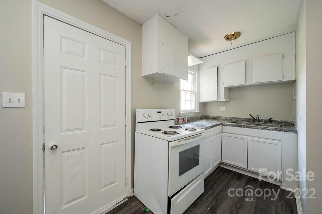 1219 County Home Road Conover, NC 28613 - Photo 16 of 48 a kitchen with a stove sink and cabinets
