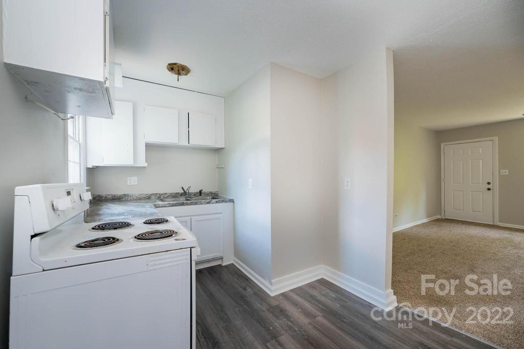 1219 County Home Road Conover, NC 28613 - Photo 17 of 48 a kitchen with a stove and a refrigerator