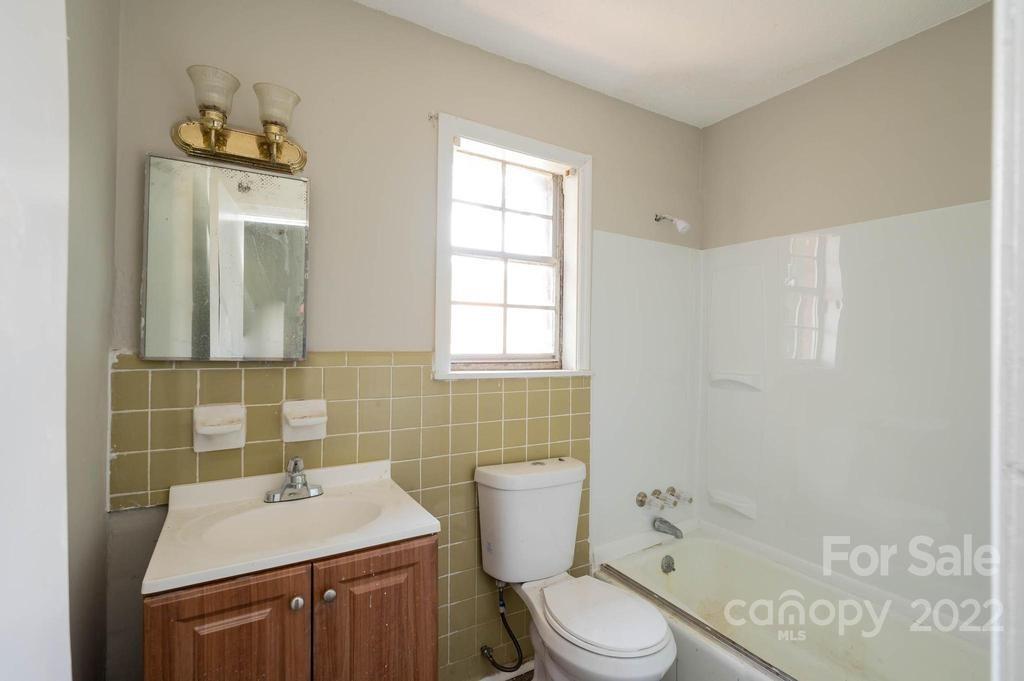 1219 County Home Road Conover, NC 28613 - Photo 19 of 48 a bathroom with a sink toilet and mirror