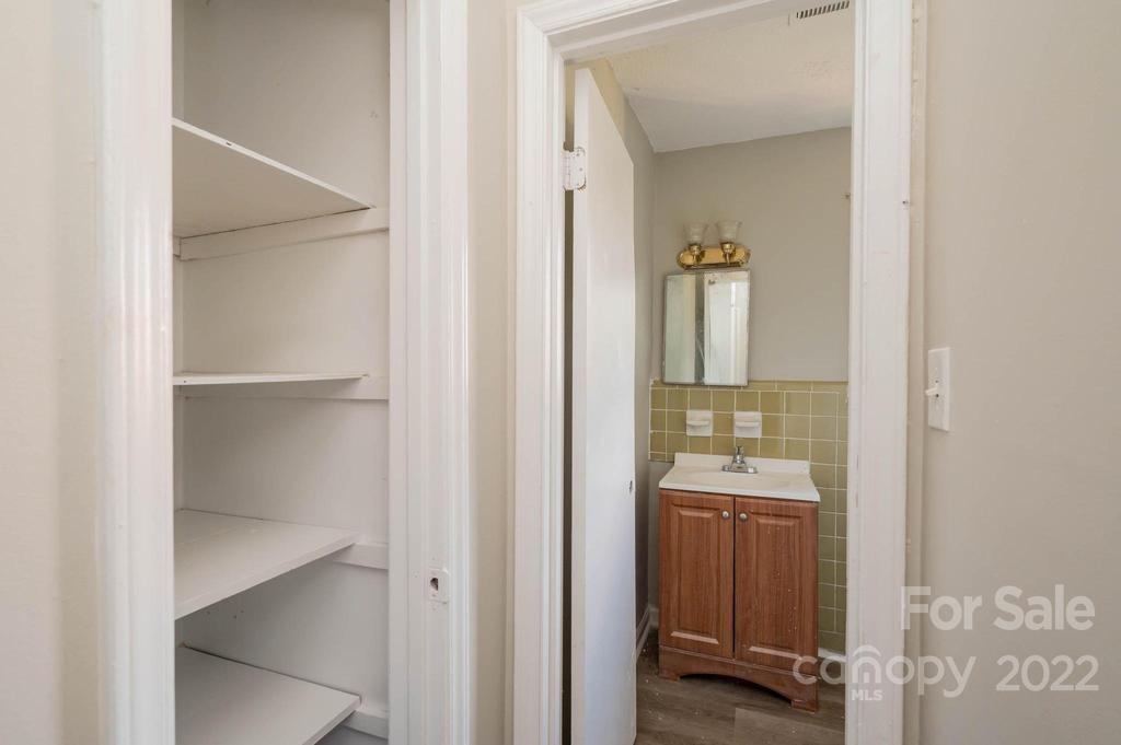 1219 County Home Road Conover, NC 28613 - Photo 22 of 48 a en suite bathroom with a sink and mirror