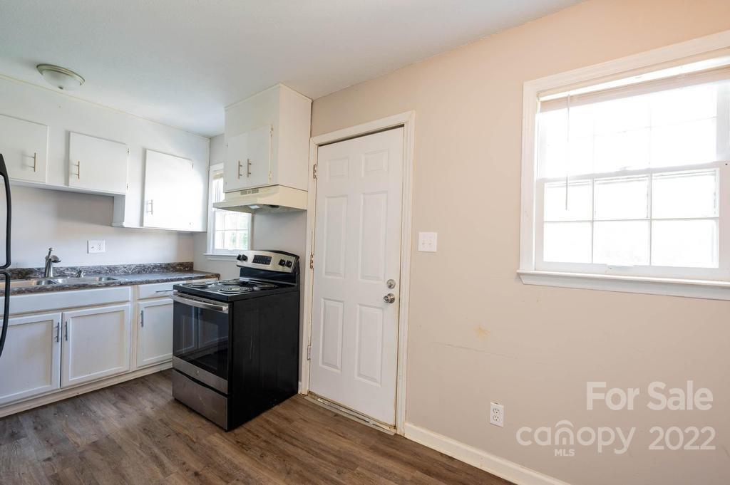 1219 County Home Road Conover, NC 28613 - Photo 23 of 48 a kitchen with stainless steel appliances granite countertop a stove and a refrigerator