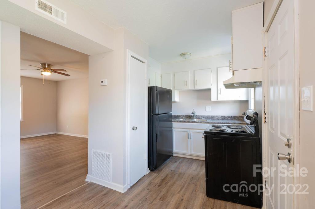 1219 County Home Road Conover, NC 28613 - Photo 24 of 48 a kitchen with stainless steel appliances granite countertop a stove a refrigerator and a refrigerator